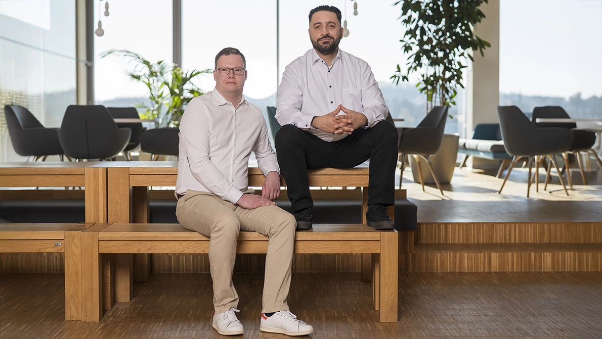 Two business men sitting on bench at KOMSA cafetaria